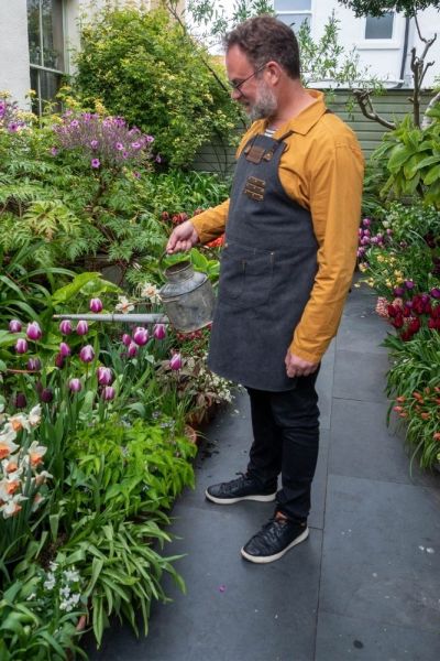 Dan Cooper watering his garden