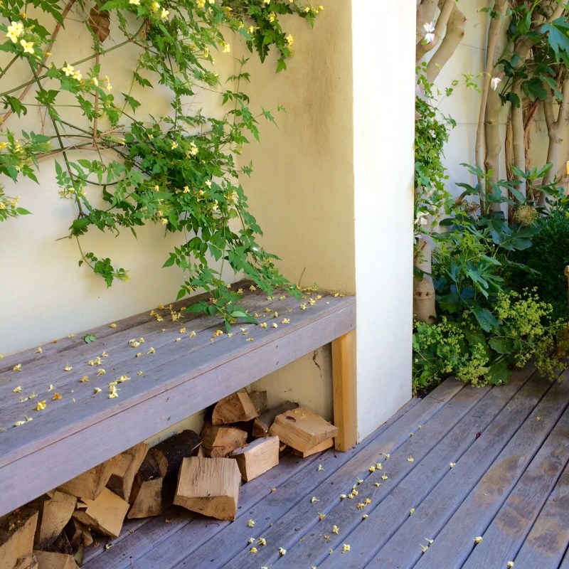 A log fire makes an urban garden warm on chilly summer nights.