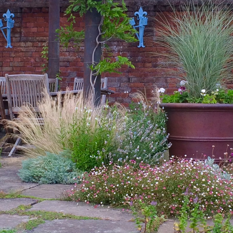 Grasses in copper pot at Doddington Place Gardens