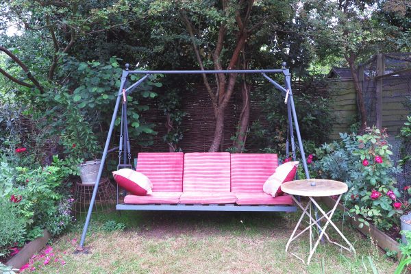 Grey painted swing bench to echo the grey roof tiles