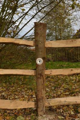 The landscaper added a hidden downlighter to this post-and-rail fence