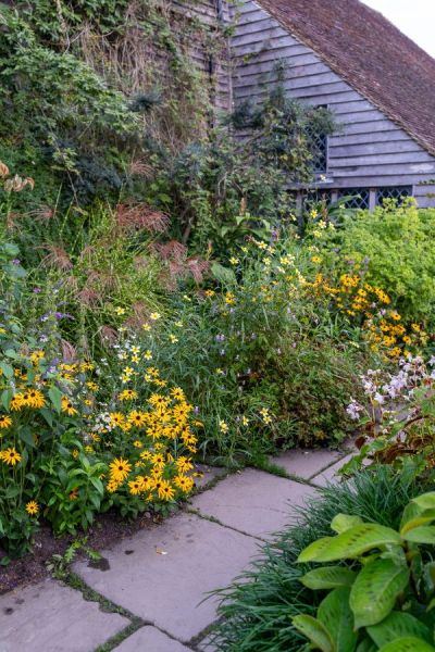 The Barn Garden is packed with flowers and plants, so they don't have to weed often.