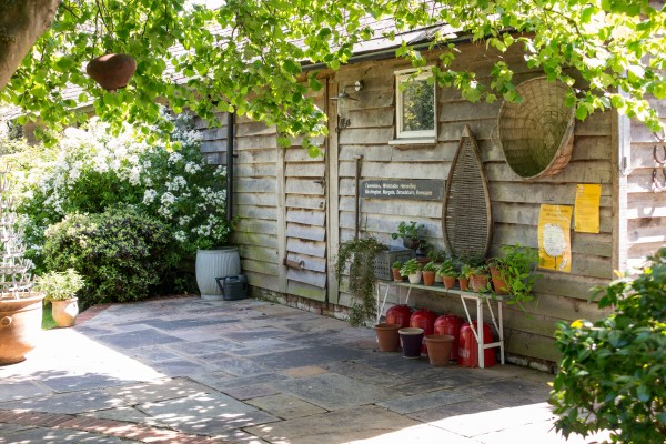 Add an old sign to your shed and display pots outside it