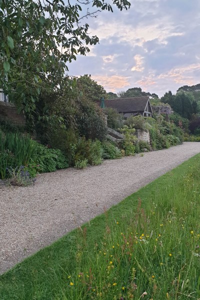 Mixed border and wild flower meadow at Gravetye Manor