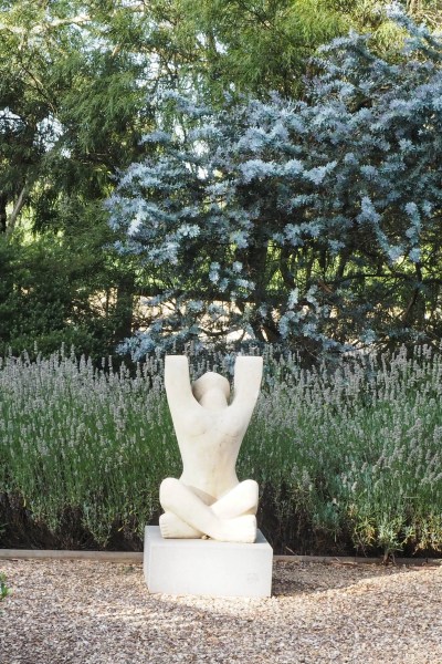 Combine blue foliage and white stone sculpture #gardendesign