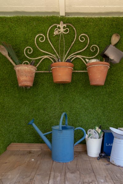 Organise the shed by using terracotta and tin pots to store smaller items